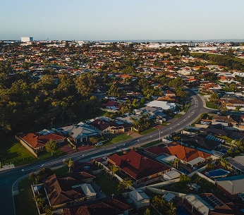 Residential suburb aerial view with main road and dense housing